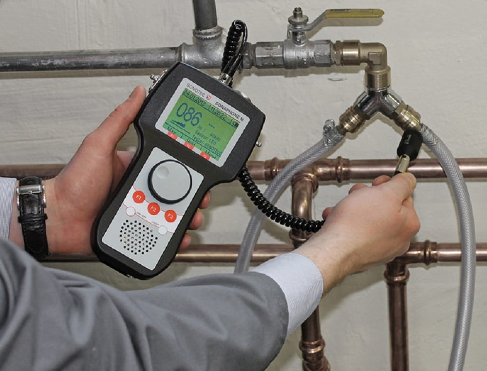 Plumber testing pipes with electronic leak detection equipment in Holladay